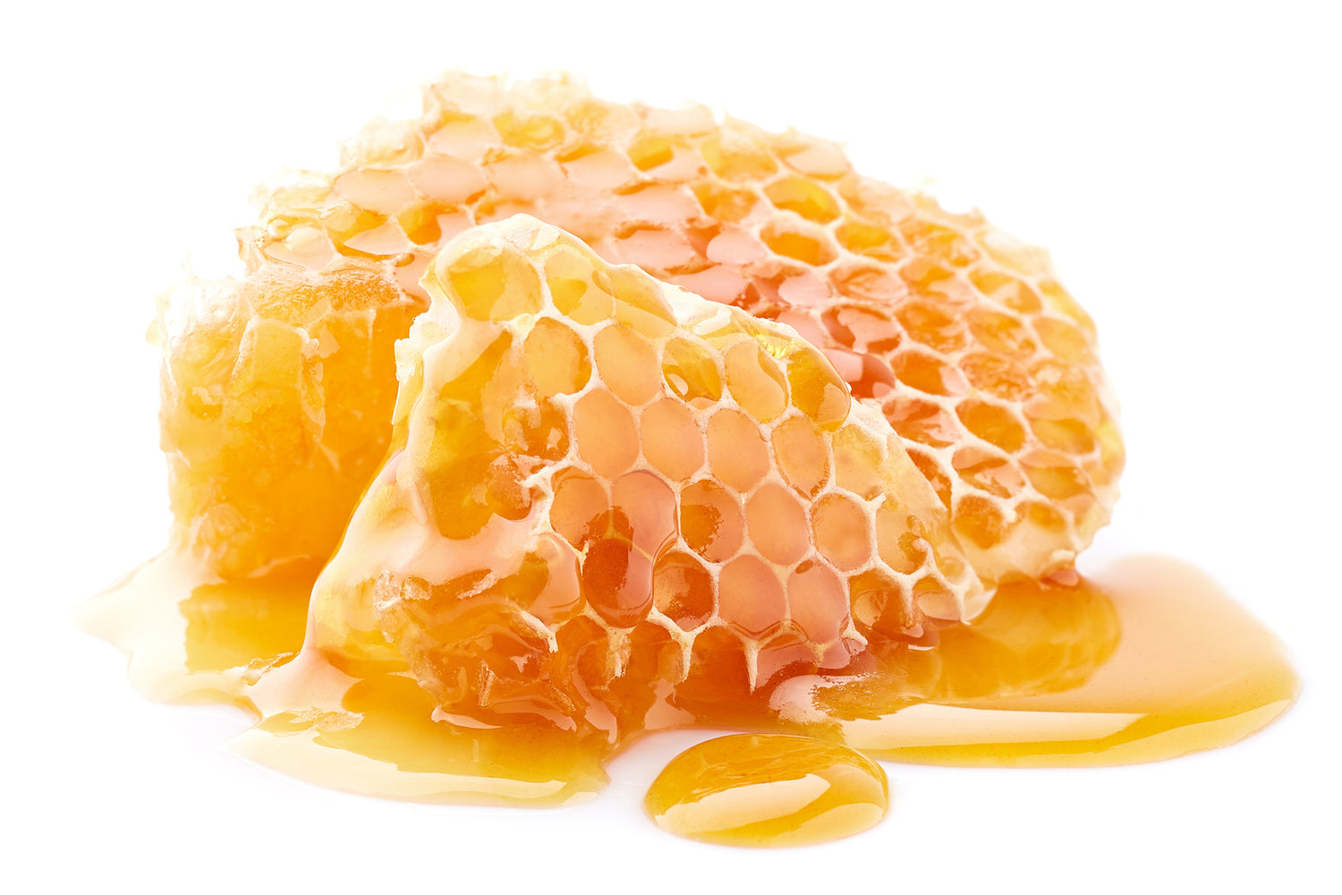 a piece honey comb decorated with some liquid honey